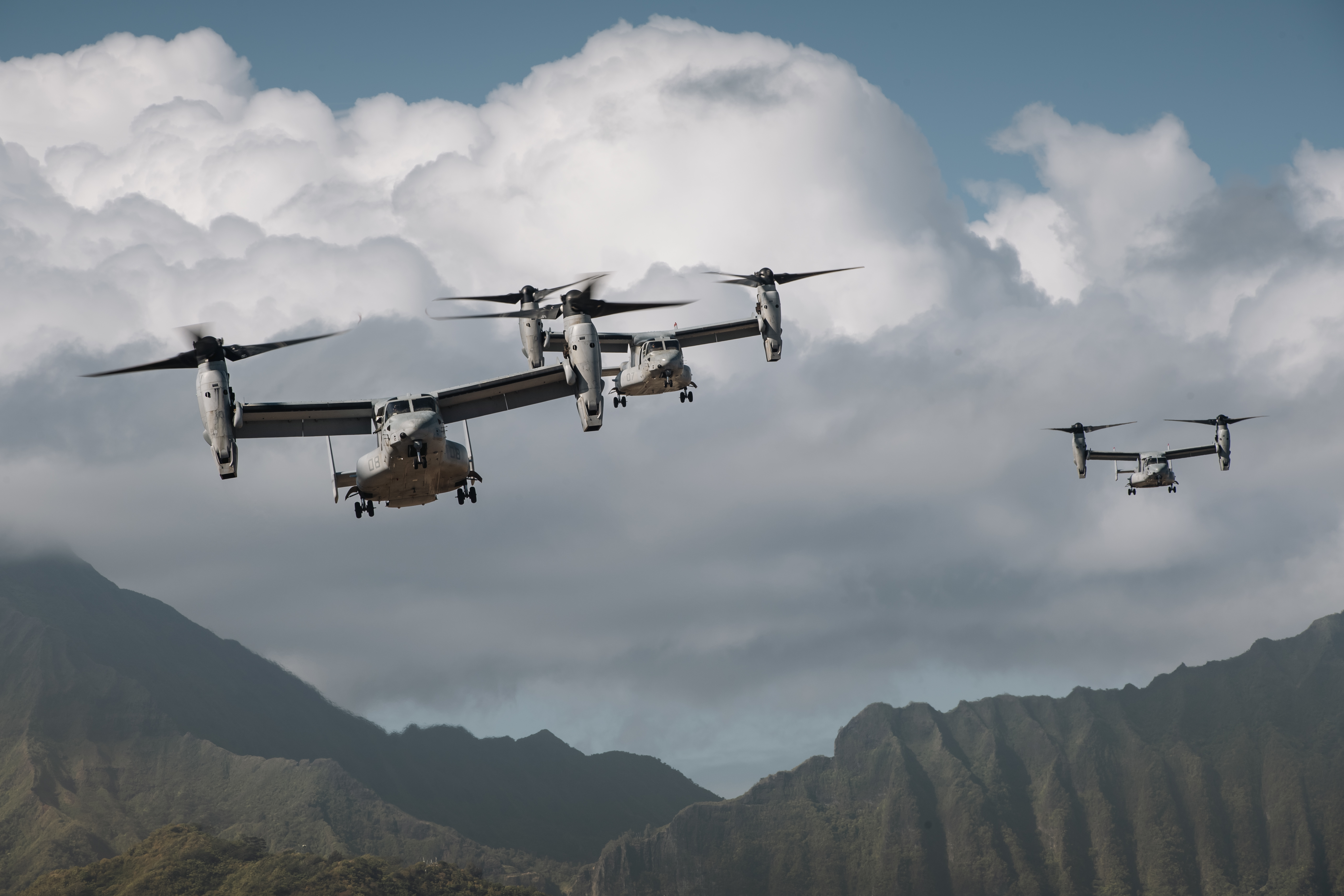 This is an image of United States Navy MV-22 Ospreys taking-off over Marine Corps Base Hawaii.